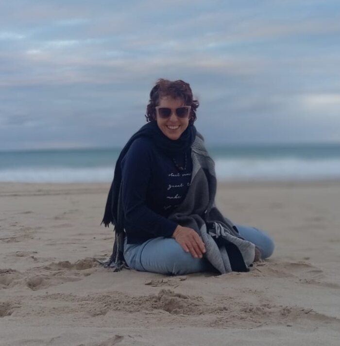Cheryl sitting on the beach